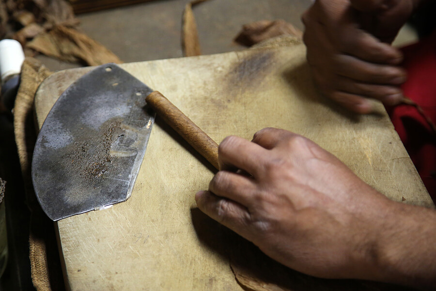 A hand-rolled cigar enters its final stages of production.
